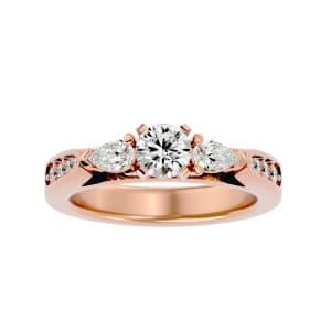 round cut pear side stone tapered pinpoint-set diamond three stone engagement ring with 18k rose gold metal and round shape diamond